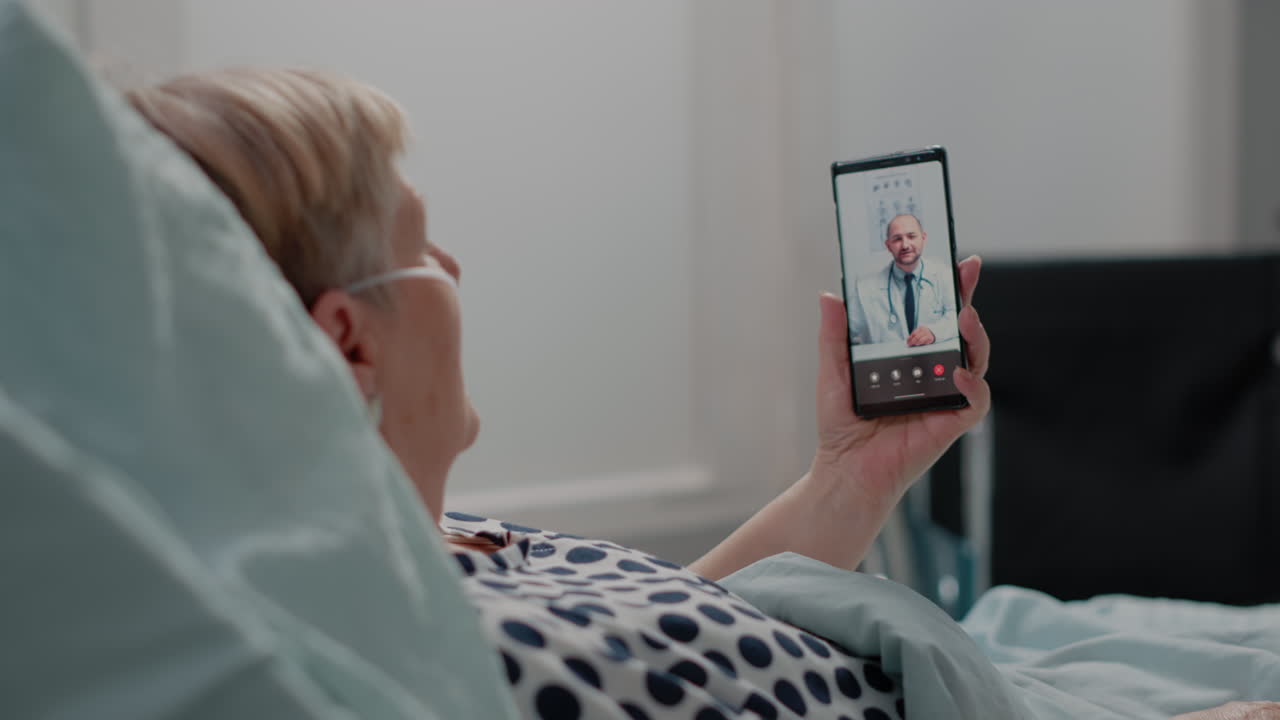 Sick woman holding smartphone for video call consultation