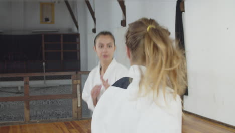 handheld shot of girls bowing before starting karate training