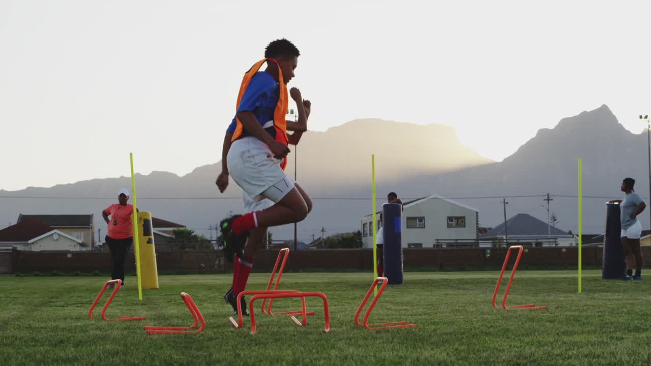 Young adult female rugby team training