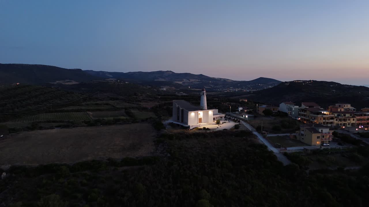 Aerial view of sunset over Castelsardo and church in Sardinia, peaceful mood