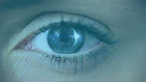 animation of woman's eye opening and closing with scrolling white digital information