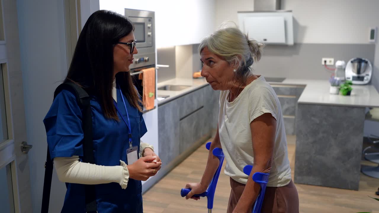 Caregiver Assisting Senior Woman with Crutches at Home