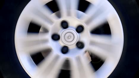 car wheel with shiny silver rim rotates