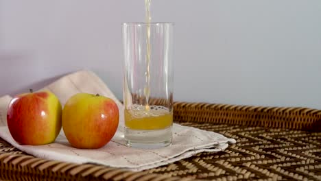 slow motion apple juice or apple cider vinegar poured into a glass