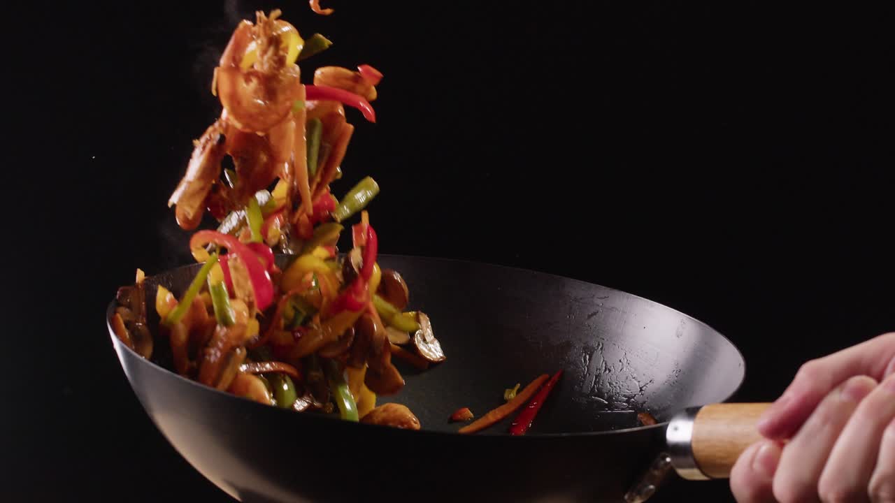 Stir-frying vegetables and chicken in a wok