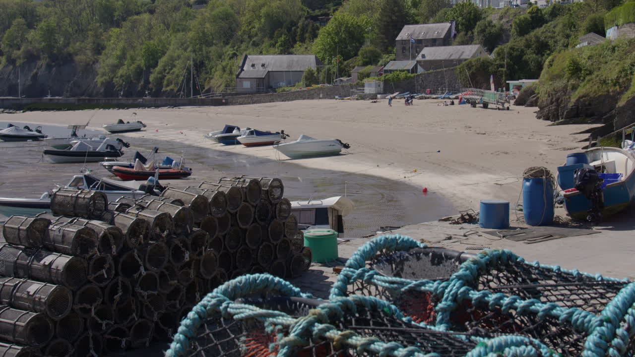 shot of new quay harbour at low tide with Lobster pots in foreground