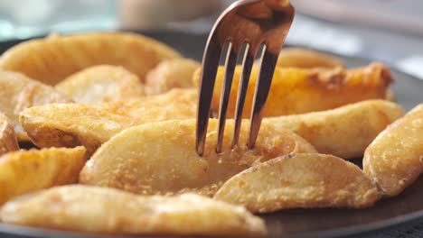 crispy potato wedges with fork