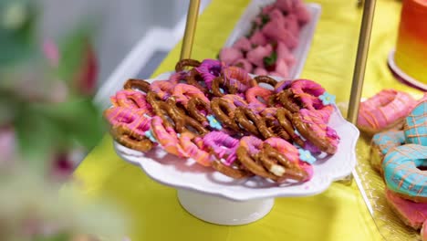 pan of pretzels on the table with icing and sprinkles