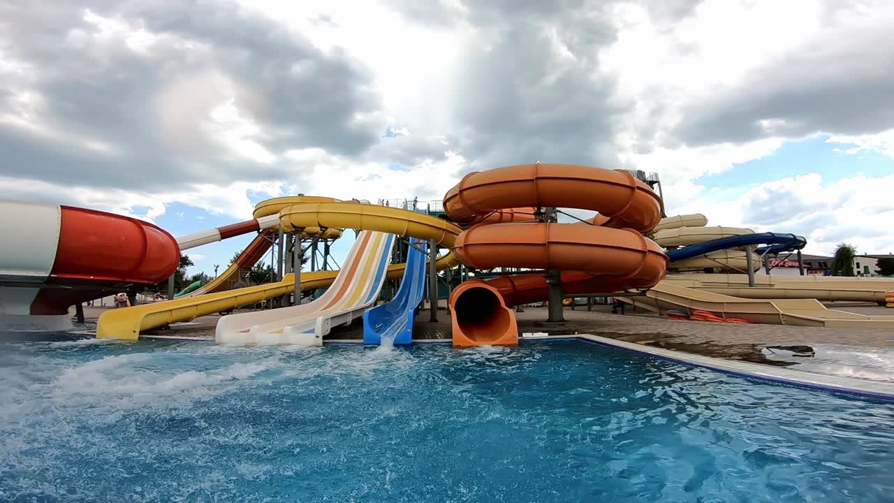 Man having fun in a water park. Slow motion