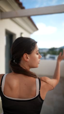 woman dancing on a balcony