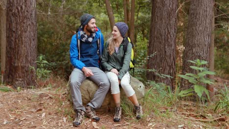 hiker couple sitting together on rock
