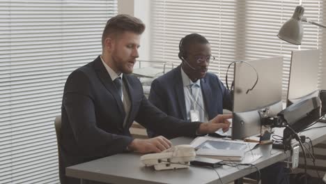 male traders working with clients in office