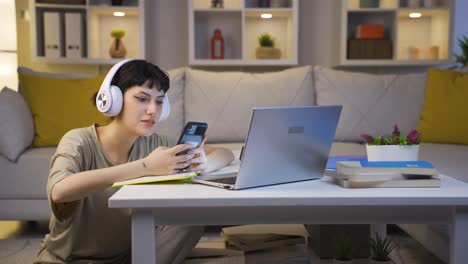 phone addicted young woman at home at night.