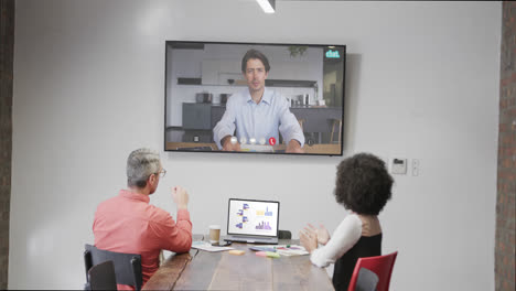 diverse business people on video call with caucasian male colleague on screen