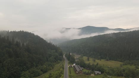 straight road cutting through a beautiful valley in ukraine, europe, on overcast day