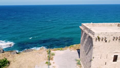 Ancient-Stone-Structure-Of-The-Fidar-Tower-By-The-Sea-In-Lebanon---aerial-shot