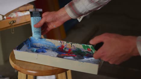 primer plano de un artista mezclando colores en un paladar
