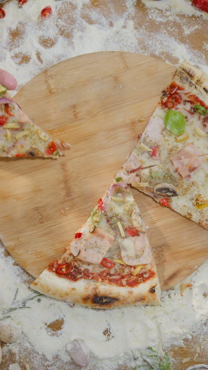 Making pizza with tomato sauce, mozzarella, onions, mushrooms, basil and ham
