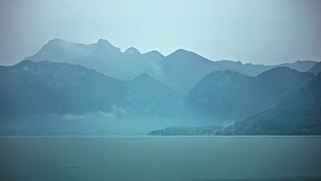 foggy attersee lake and alps, time lapse view