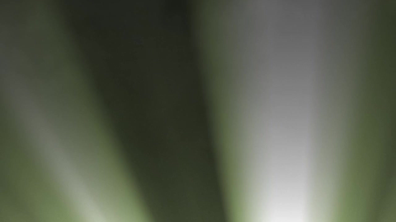 Abstract Green and White Light Rays Moving on Dark Background