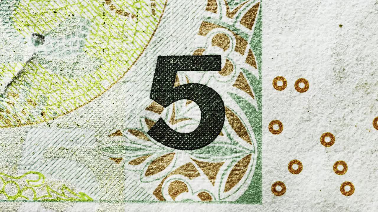 Stop-motion animation aligning the number five across different international banknotes