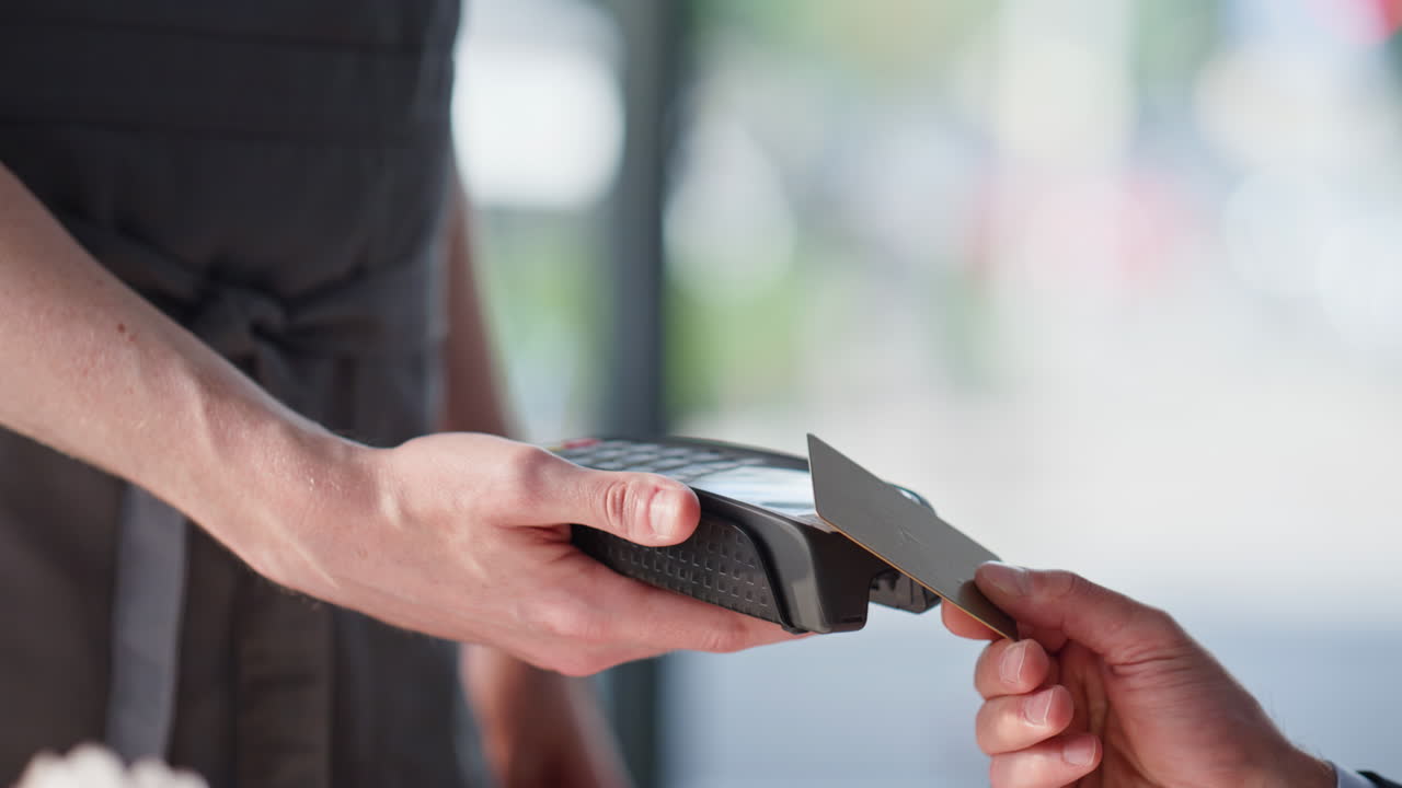 Closeup man making payment for cafeteria service using credit card for terminal