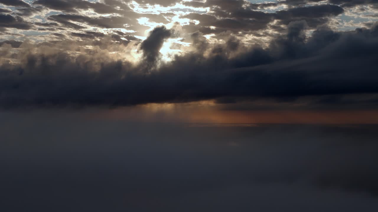 una vista del sol a través de las nubes desde una ventana de un avión al atardecer o al amanecer