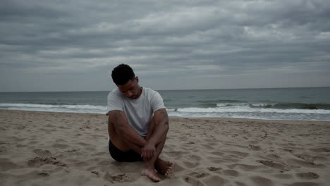 a man sitting alone on a beach