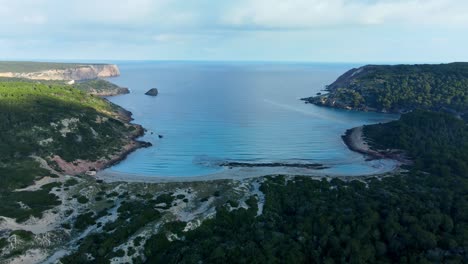 Aerial panoramic overview of La vall menorca virgin beach calm day in shade