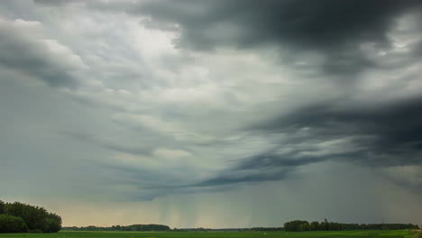 rain clouds over the farmland - time lapse