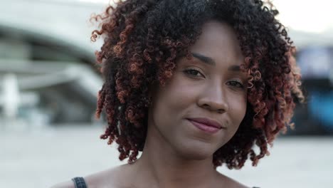 closeup shot of smiling woman posing on street