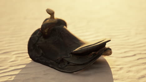 old horse saddle on the beach