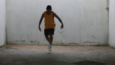 dancing man young happy street dancer performing various freestyle dance moves fit mixed race male practicing in grungy warehouse wearing yellow vest