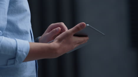 Businessman-hands-using-tablet-at-downtown-area-closeup.-Manager-checking-email.