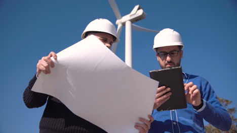 engineers reviewing wind turbine plans