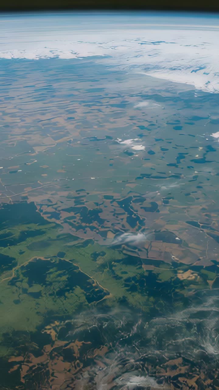 Vertical video: Opening revealing aerial view drifting over farmland and lakes with horizon
