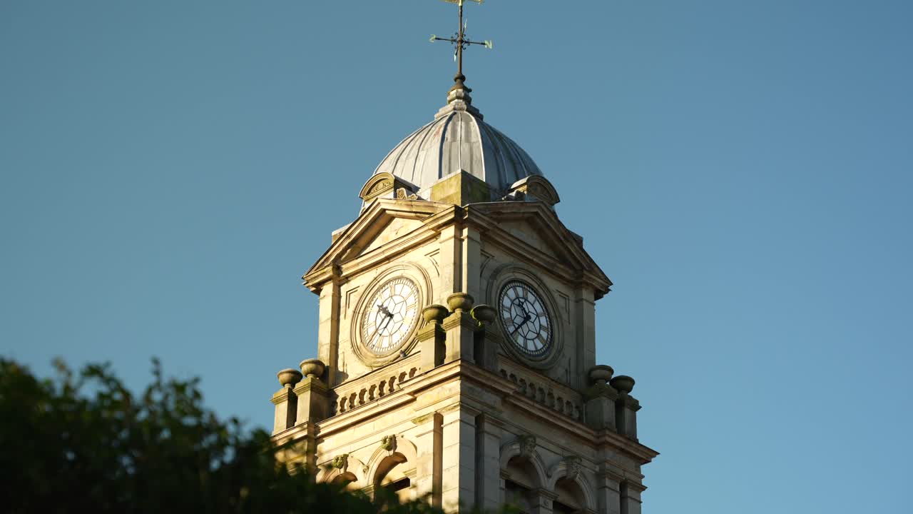 Traditional clock tower monument with weather vane in Buxton, Peak District, UK