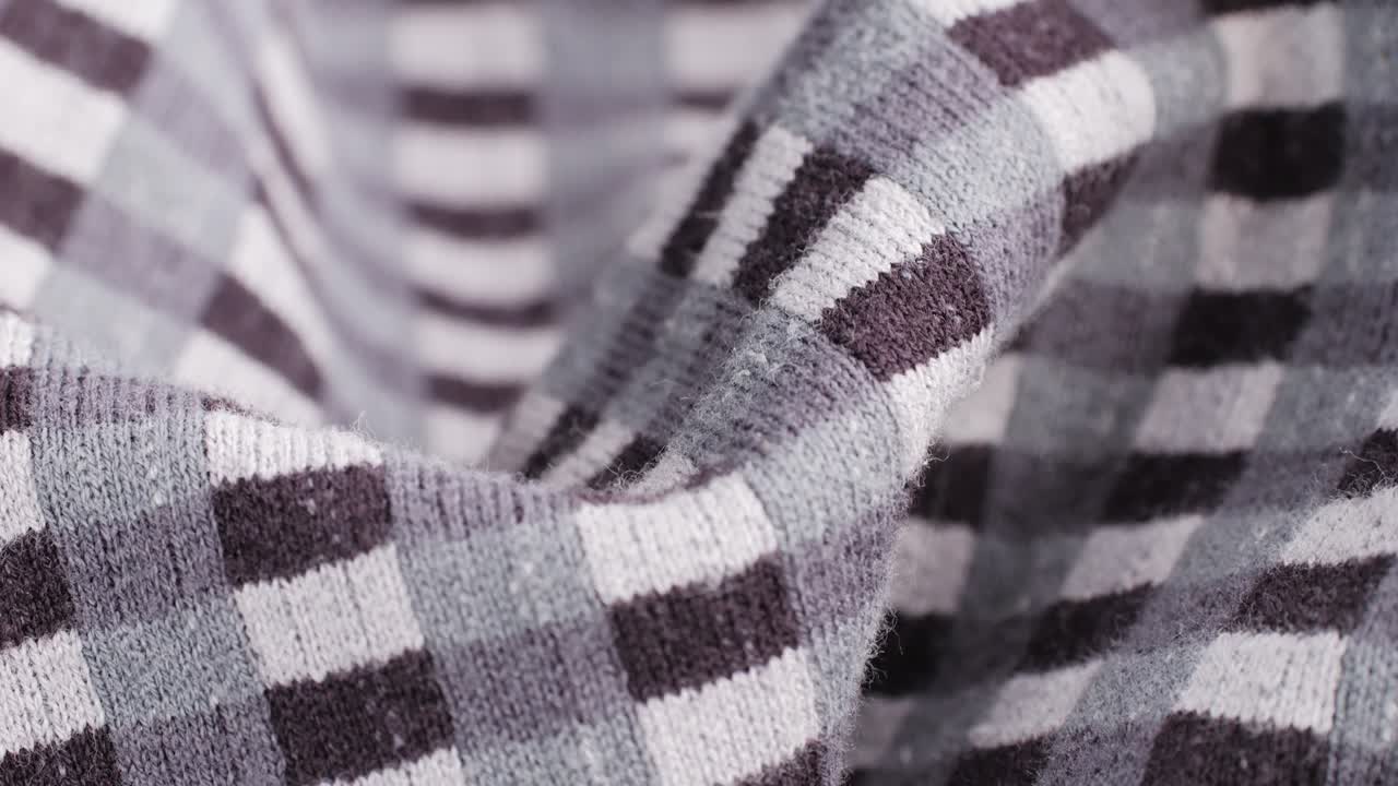 Checkered print textile cloth texture close-up macro. Black and white clothes.Fashion fabric multicolor.High quality 4k footage