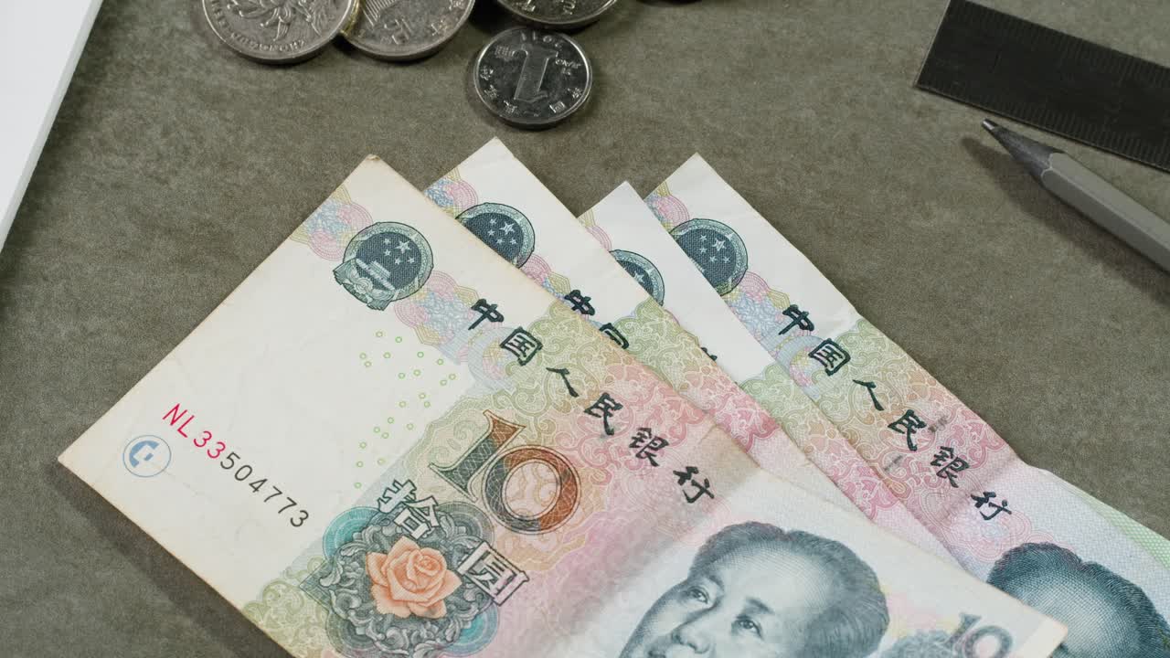 Chinese Yuan banknotes and coins on a desk