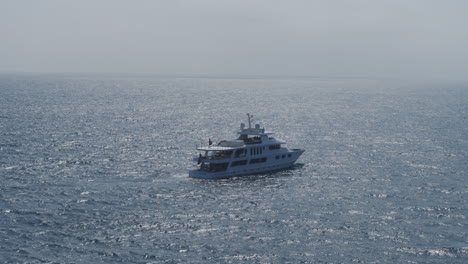 Establishing-shot-of-an-expensive-yacht-sailing-through-the-ocean