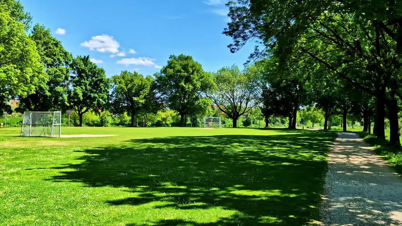 Football Field With Green Grass And Trees In Summer In Regensburg, Germany. - wide shot