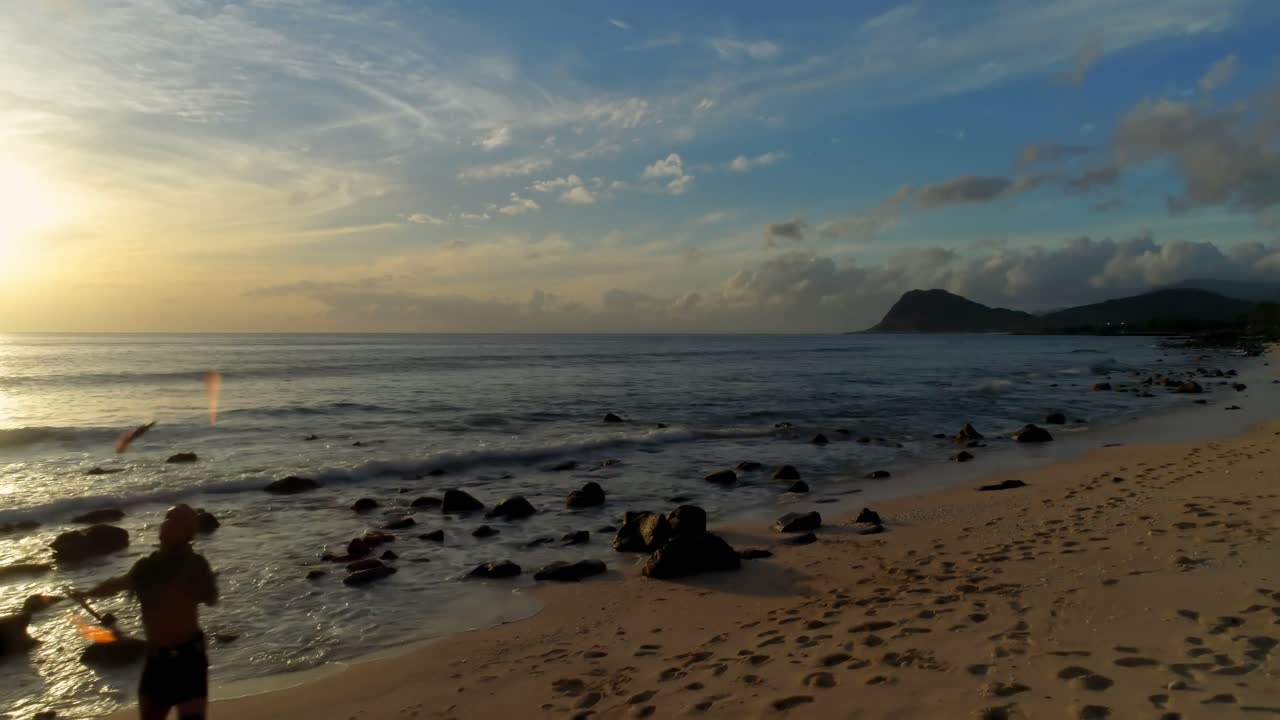 hombre jugando con fuego en la playa 4k