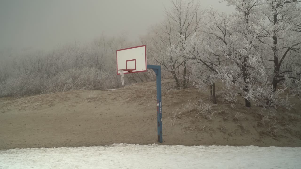 frozen, snowy basketball court on a foggy P&auml;rnu beach, Estonia