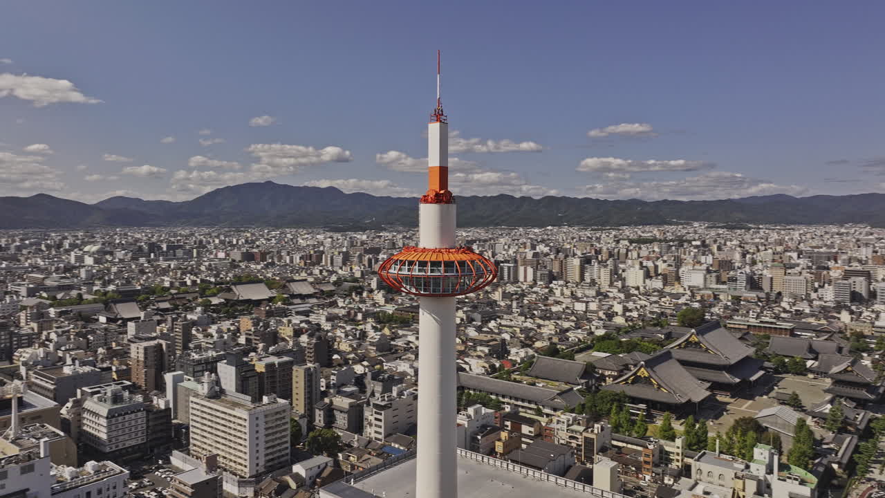 Kyoto Japan Aerial v75 panoramic views, fly around the iconic observation tower capturing train station and downtown cityscape against mountainous backdrop - Shot with Mavic 3 Pro Cine - Oct 8th 2023