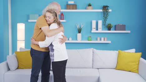 the woman who welcomes her husband at home. happy couple.