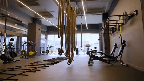 modern empty gym with fitness equipment and ropes