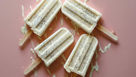 vanilla ice cream popsicles on pink background