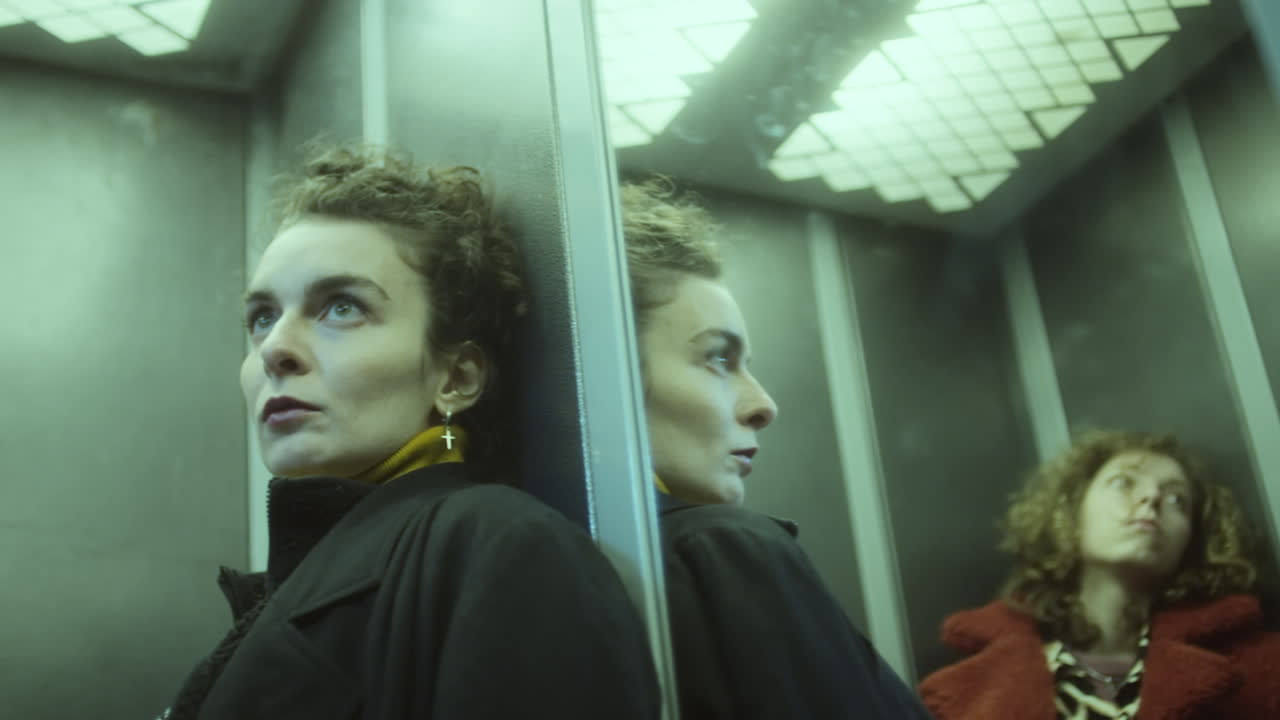 Pensive Woman Riding Elevator