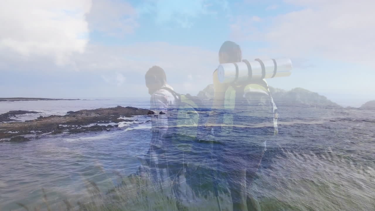 Hiking partners exploring rocky shoreline by ocean, with animated heart rate graphs