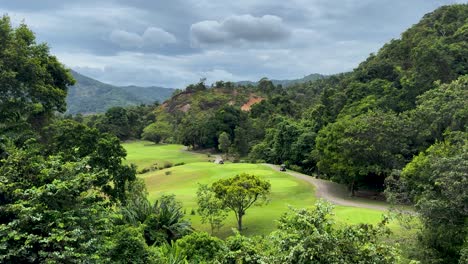 scenic lush golf course surrounded by mountains in phuket, thailand